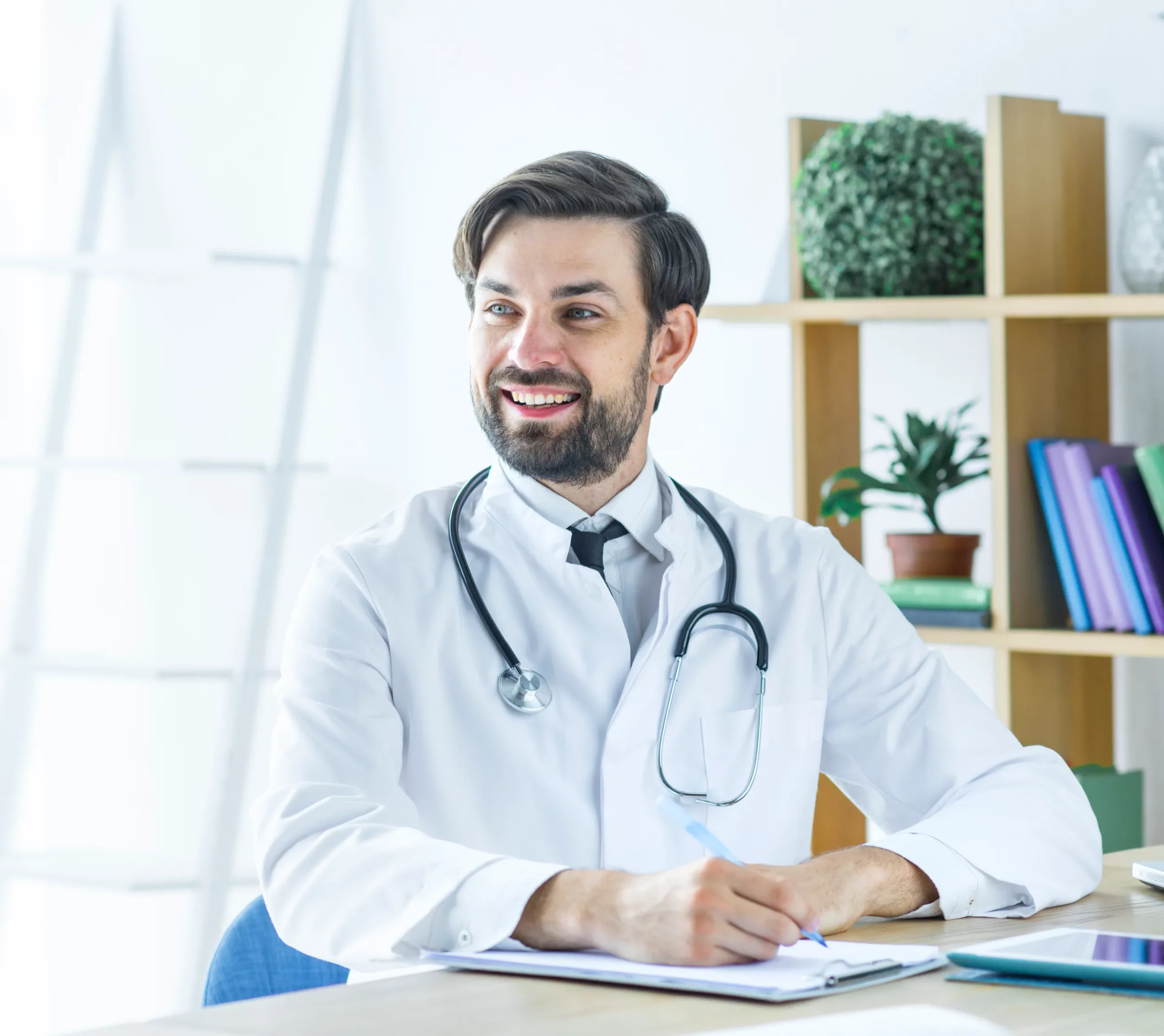 A smiling doctor writing on a chart