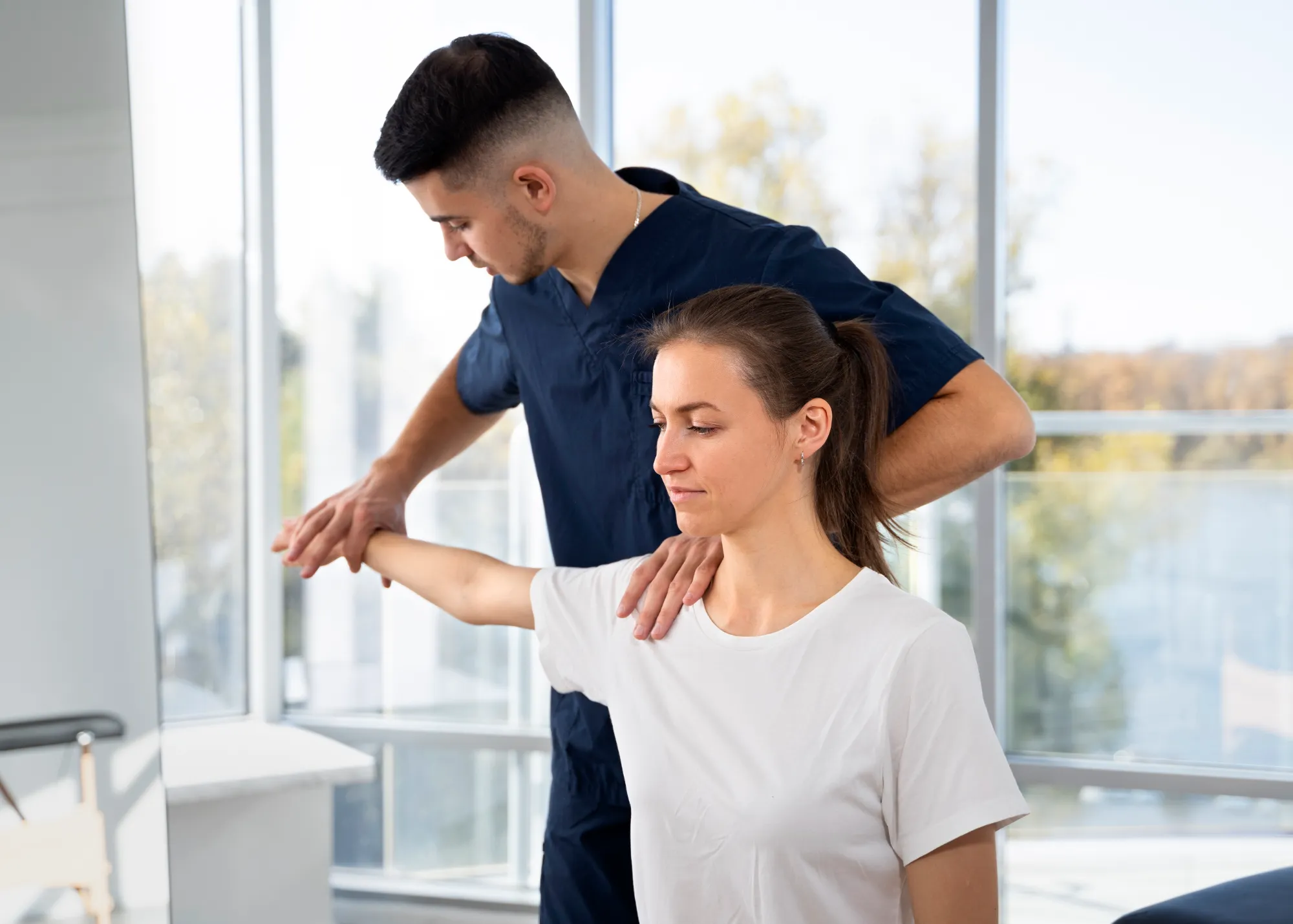 A nurse manipulating a patients arm and shoulder